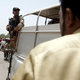 A paramilitary soldier stands guard on a van outside the hospital after an attack on a bus in Karachi, Pakistan on May 13, 2015.